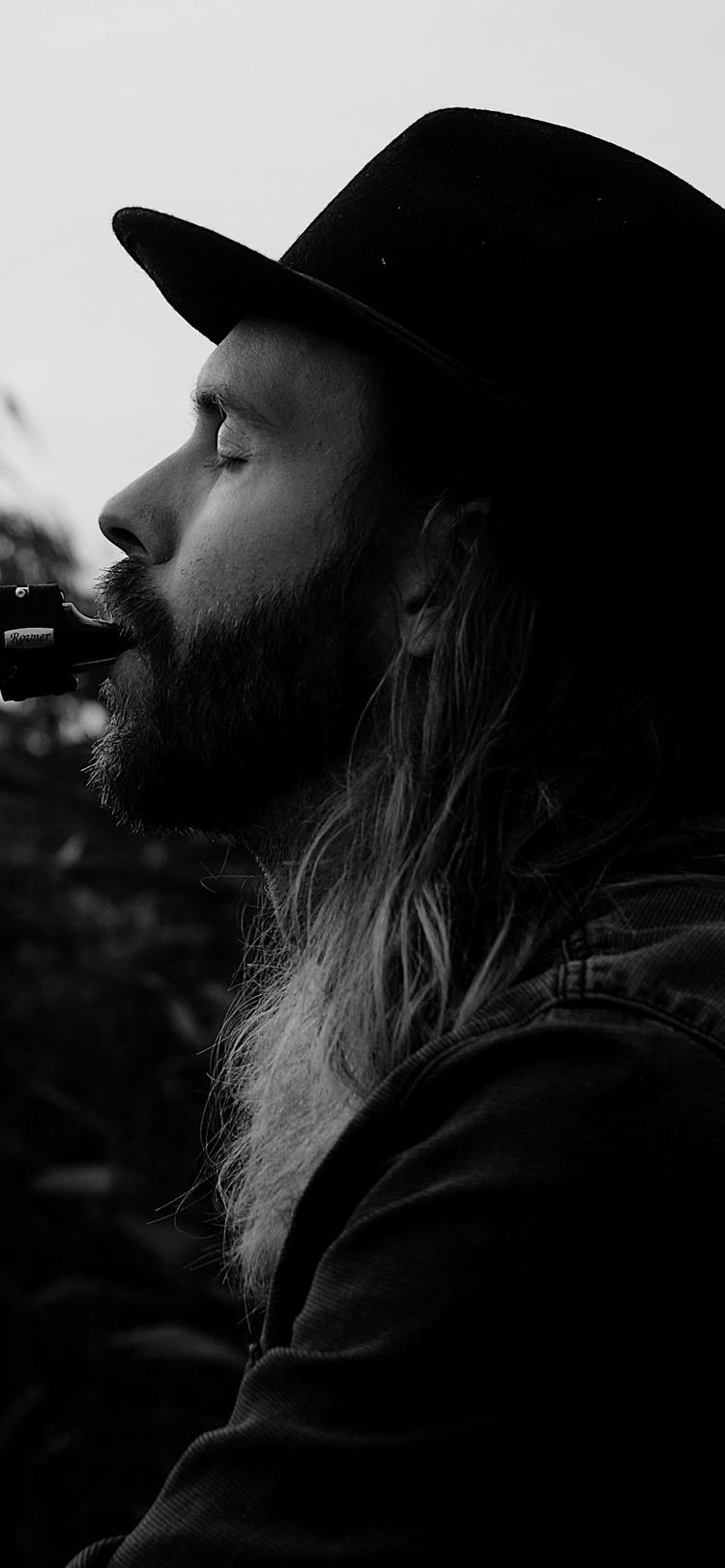 Björn playing the saxophone with his eyes closed, in front of reeds